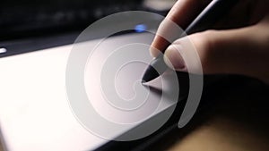 Creative worl. Young caucasian designer working with graphics pen tablet, hands of a man working with drawing tablet for