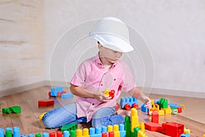 Creative young boy playing with building blocks