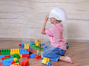 Creative young boy playing with building blocks