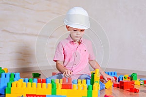 Creative young boy playing with building blocks