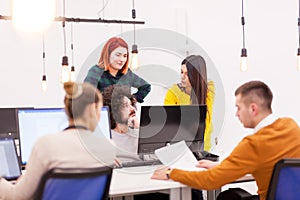 Creative young individuals working on desktop computers in a modern office space