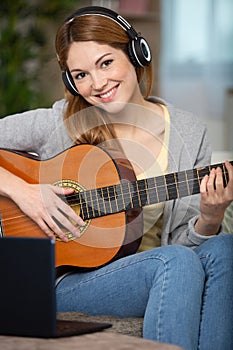 creative young woman with guitar composing new song