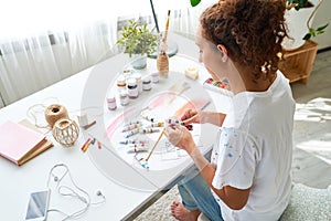 Creative Young Woman Painting with Oils