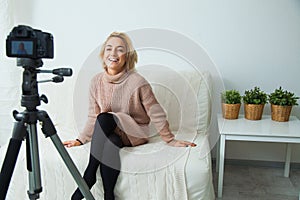 Creative young woman recording video blog for social media network.