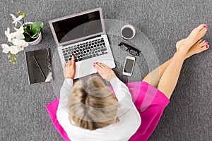 Creative young woman working with computer, view from above