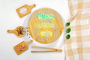 A creatively arranged display featuring text announcing National Nutrition Month by natural food elements.