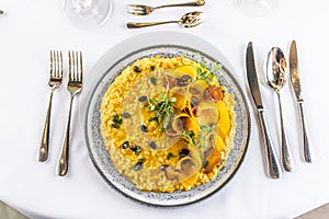 Creatively cooked pumpkin risotto served on a ceremonially prepared table in the hotel restaurant