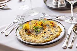 Creatively cooked pumpkin risotto served on a ceremonially prepared table in the hotel restaurant