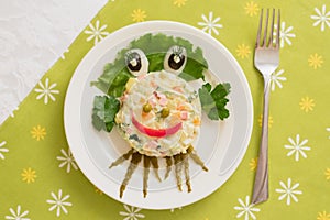 Creatively decorated octopus salad. Children`s menu on a green background.