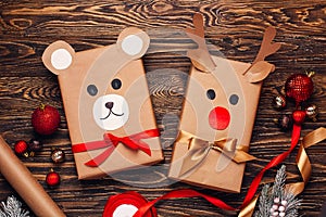 Creatively wrapped Christmas gifts in the shape of a teddy bear and a deer. New Year and Christmas concept. DIY gift wrapping.