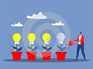 Creativity business growth concept, businessman watering plant with a light bulb on it creating ,creating a new solution