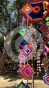 Creativity, colorful silk yarn mobile hanging out in the open, outdoor image for selectable focus background.