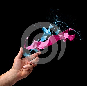 Creativity concept hand throwing paint on black background