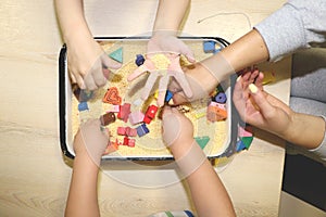 Children playing with kinetic sand, croup and designer in preschool. The development of fine motor concept. Creativity Game