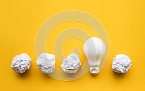 Creativity ideas with lightbulb and paper crumpled ball