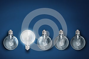 Creativity innovation illuminated light bulb row dim ones concept solution