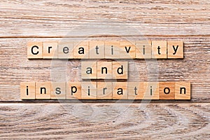 Creativity and inspiration word written on wood block. creativity and inspiration text on wooden table for your desing, concept