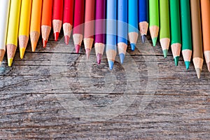 Creativity: Multi-colored pencils on rustic wooden table