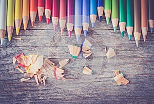 Creativity: Multi-colored pencils on rustic wooden table