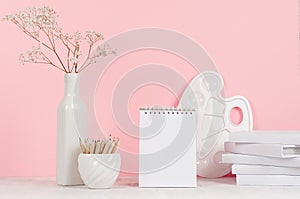 Creativity school background for girl`s - white stationery, palette, pencils and blank notepad on soft pink wall and white wood.