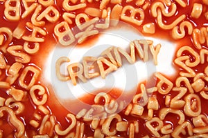 Creativity written in spaghetti pasta letters surrounded with jumbled letters photo