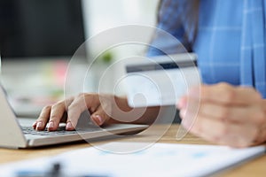 Credit bank card in hand and computer keyboard