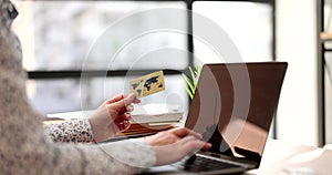 Credit bank card in hand and computer keyboard