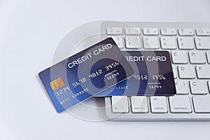 Credit card on computer keyboard on white desk. Concept of Online shopping and payment