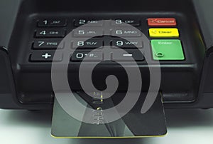 Credit Card inserted into a pin pad terminal - EMV Chip photo