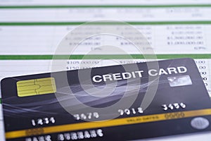 Credit card model on chart and graph spreadsheet paper.