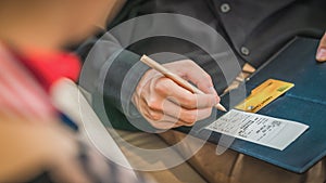 Credit card payment bill and slip with hand holding pen ready to sign to make payment