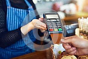 Credit card payment, cafe and hands with a machine at a restaurant for a service or food. Bakery, pay and a customer