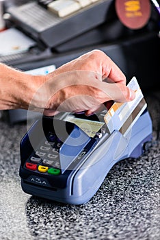 Credit card payment at terminal in shop