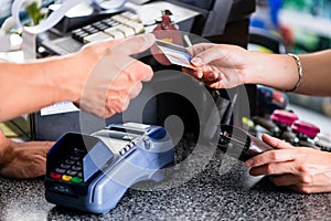 Credit card payment at terminal in shop