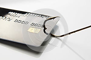 Credit card phishing attack. Credit card a fish hook, close-up