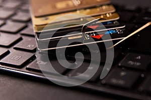 Credit card phishing attack over dark background, close-up