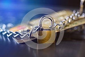 Credit card security, safe trading. Credit card closed with a padlock and chain