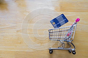 Credit card and shopping cart on wooden table. online shopping, online payment