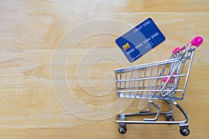 Credit card and shopping cart on wooden table. online shopping, online payment.