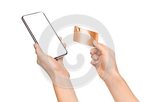 Credit card and smartphone with blank screen in female hands
