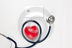 Credit card and stethoscope with red heart