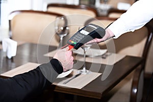 Credit card terminal for cashless payments. Customer holds credit card