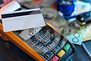 Credit card with terminal, toy car and australian dollar