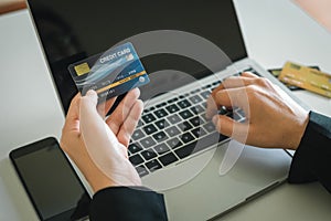 Credit card to pay, woman holding to payment and shopping online with laptop, Substitute for using cash.