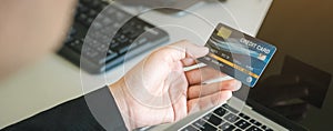 Credit card to pay, woman holding to payment and shopping online with laptop, Substitute for using cash.