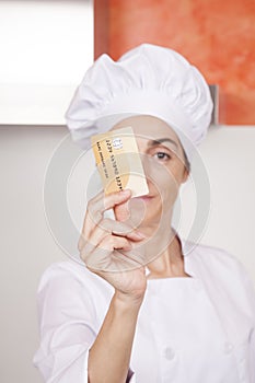 Credit card in woman chef hand