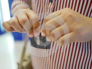 A credit card in a woman`s hands being folded and destroyed - breaking free of financial bondage