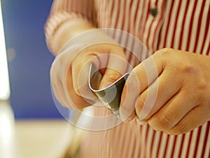 A credit card in a woman`s hands being folded and destroyed - breaking free of financial bondage