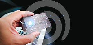 Credit cards and financial privileges concept, hand holding luxury credit card on dark background or showing credit card
