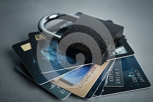 Credit cards and padlock on grey background. Protection from cyber attack